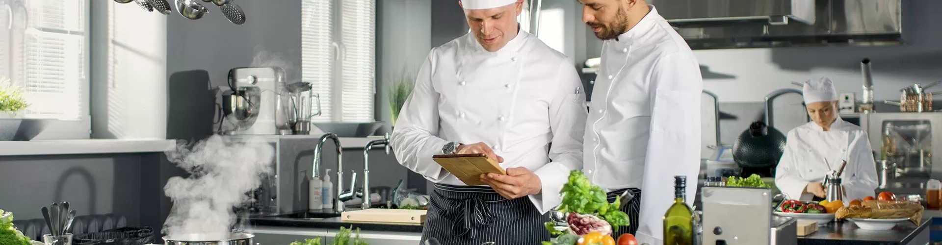 Two Famous Chefs Discuss Their Video Blog while Using Tablet Com Hotellerie & Gastronomie